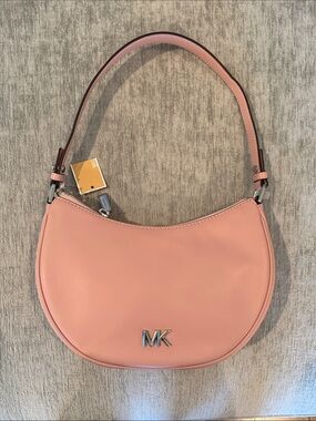 Brand new Michael Kors purse- pink. Can convert to long strap. Missed rtn window